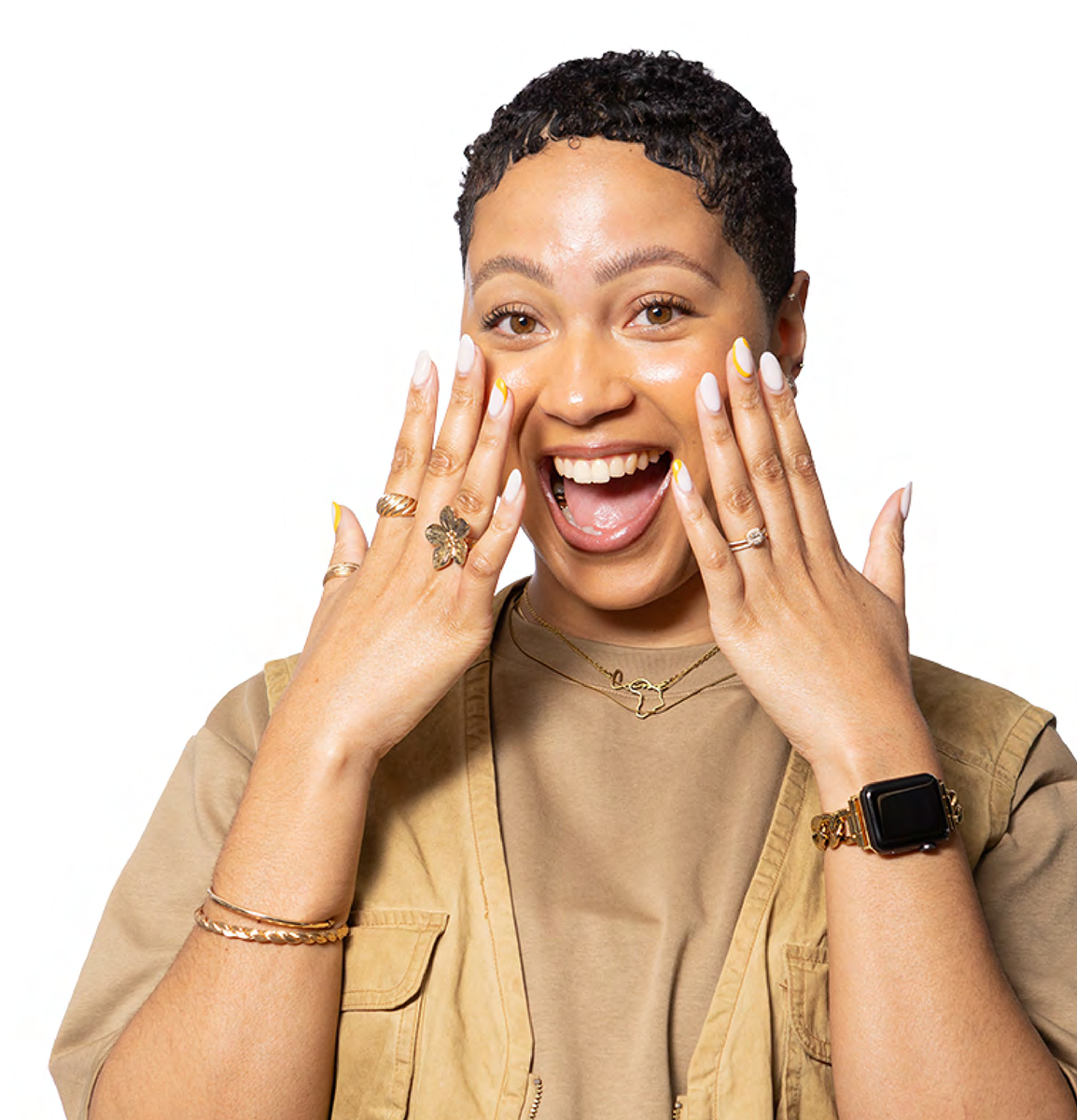 Woman smiling, hands near face, with jewelry, wristwatch, and nails.