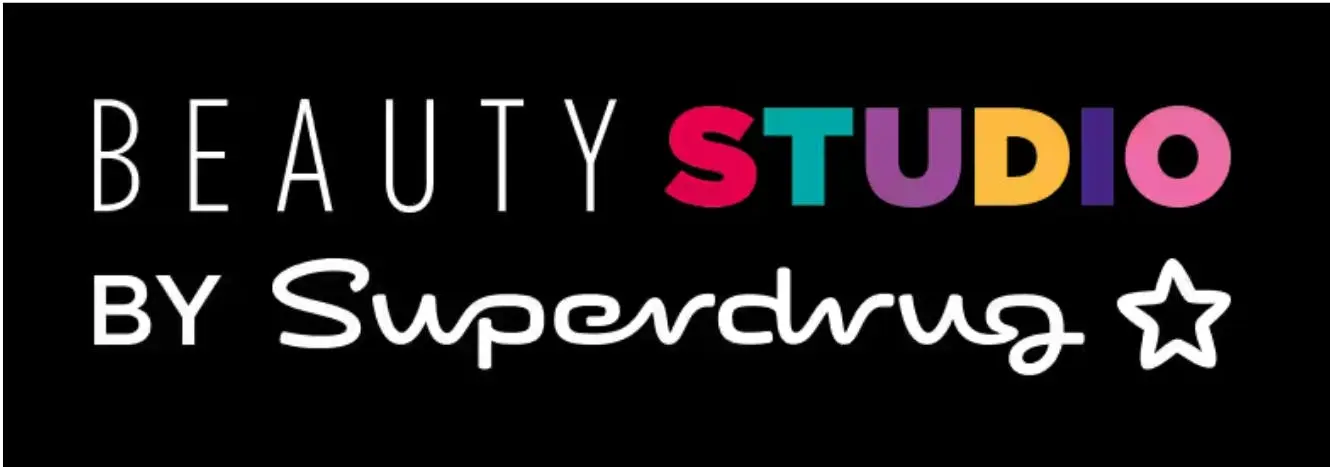 The text "BEAUTY STUDIO" is displayed with "STUDIO" in colorful letters. Below, "BY Superdrug" is written in white script, accompanied by a white star outline.