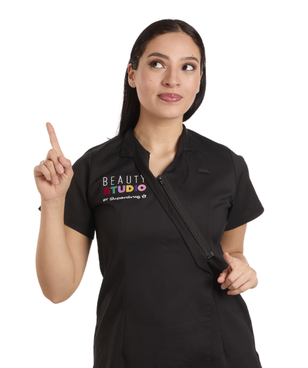Woman in black Beauty Studio uniform pointing up and looking away.